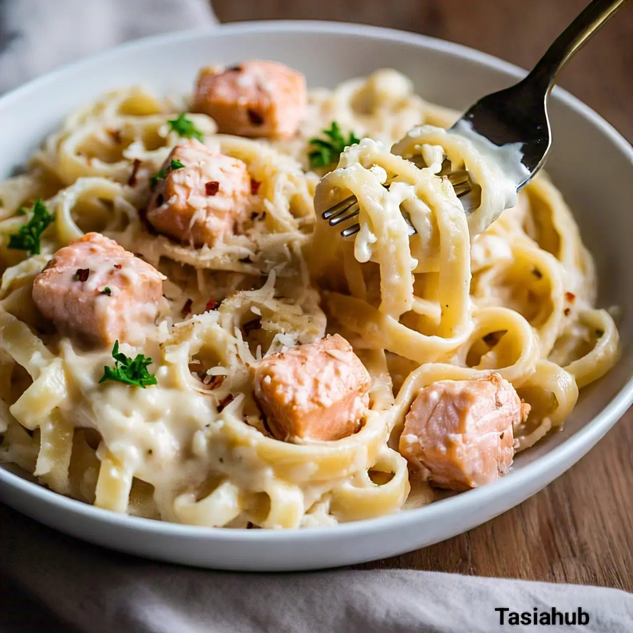A bowl of creamy salmon Alfredo pasta