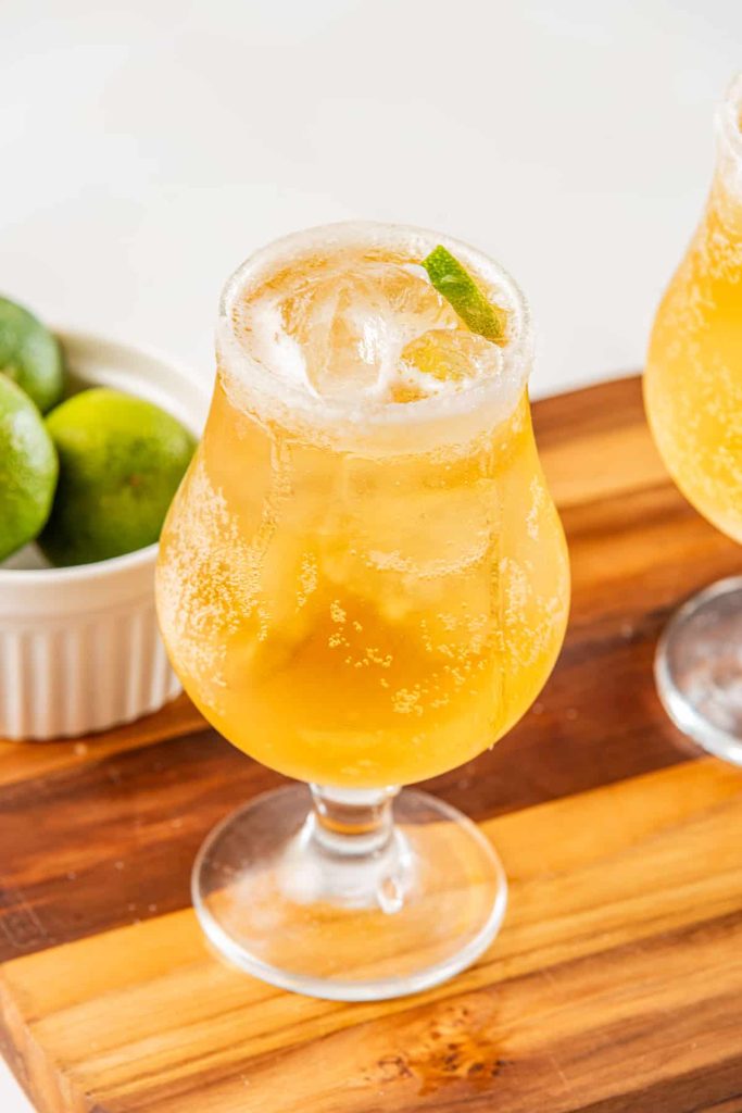 Chelada served with ice and a lime wedge as garnish